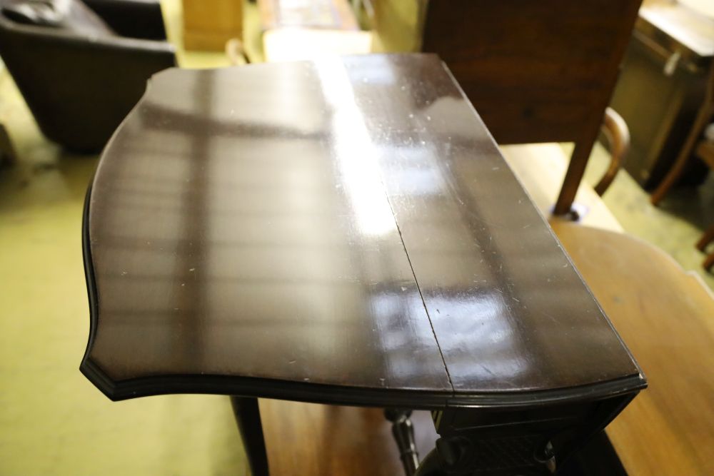 A late Victorian mahogany Sutherland table with shaped top on carved underframe, width 63cm depth 17cm height 59cm